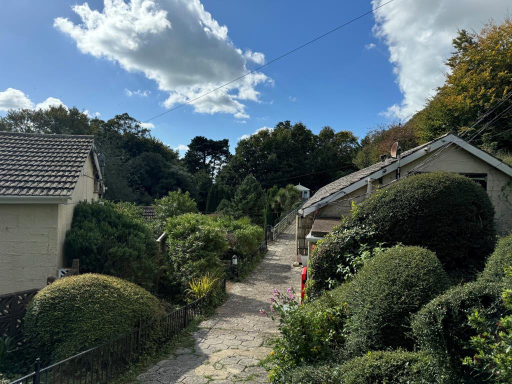 Lot: 59 - FREEHOLD GROUND RENTS FOR EXTENSIVE CHALET SITE - Path leading to Chalets